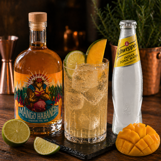 Mango habanero liqueur cocktail with Schweppes Indian Tonic Water, lime and fresh mango on ice – an exotic, fresh long drink with a gentle kick