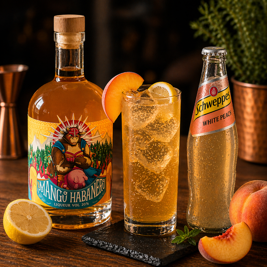 Mango habanero liqueur cocktail with Schweppes White Peach, fresh peach and lemon on ice – a fruity, sweet long drink with a gentle kick